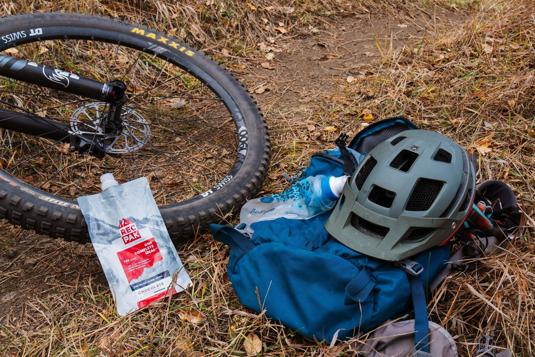 a bicycle next to a bag of Recpak, a veteran owned outdoor nutrition company