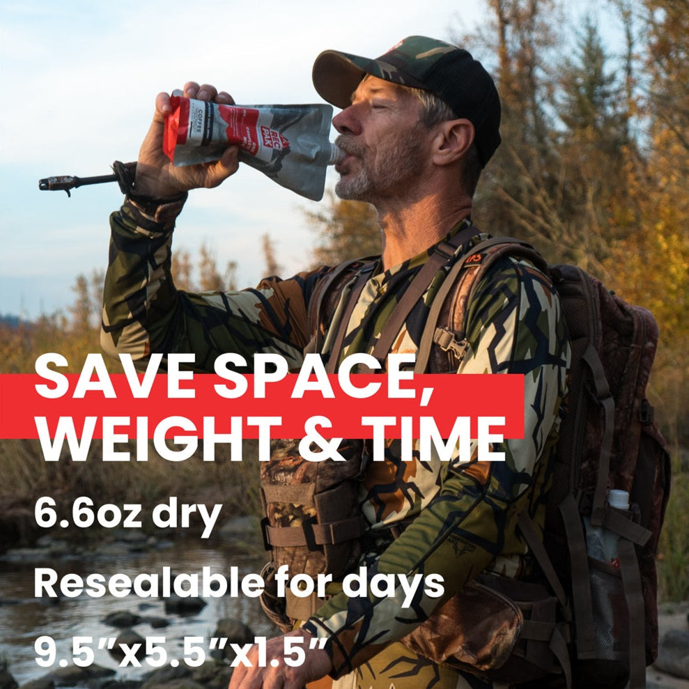 Hunter drinking RecPak easy camping meal with outdoor scenery. ultralight camping meal