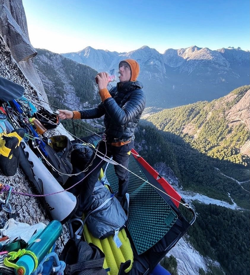 Climber on the side of a big wall enjoying recpak, a Veteran-Owned Ultralight Meal Company