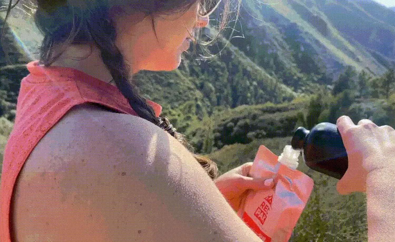 woman pouring water into a Recpak the instant no cook camping meal